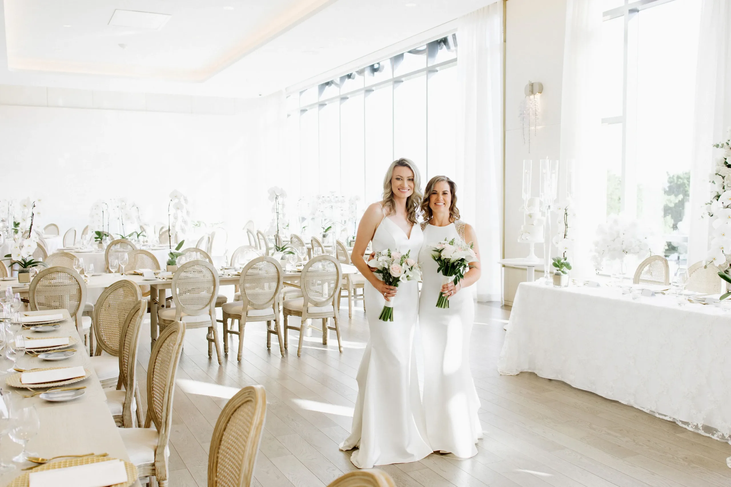 brides posing in the northshore room at the pearle hotel in burlington